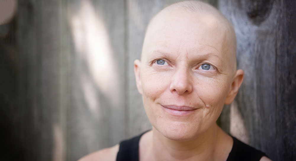 A woman smiles at the distance