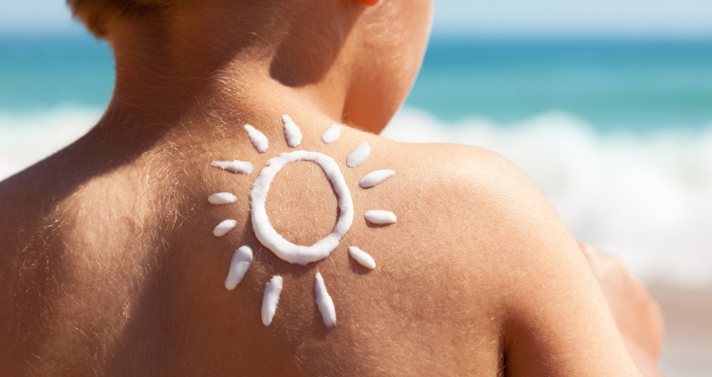 A toddler's back with sunscreen sun on it