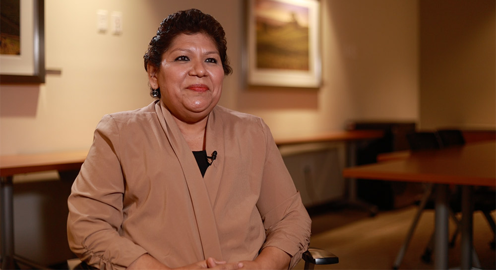 Maria Hernandez sitting in a chair prepared for an interview