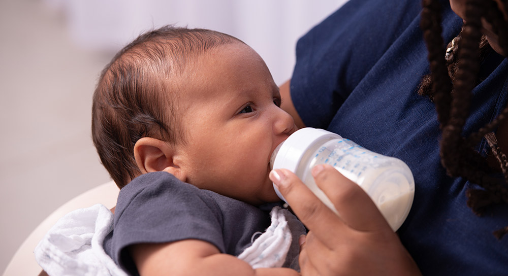 A baby drinks from a bottle