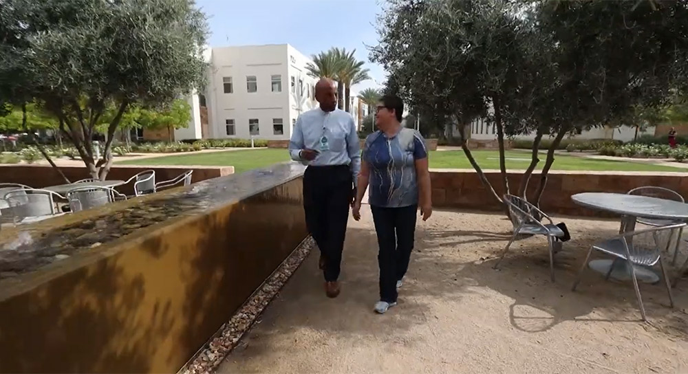 A pastor walks through a garden with a patient