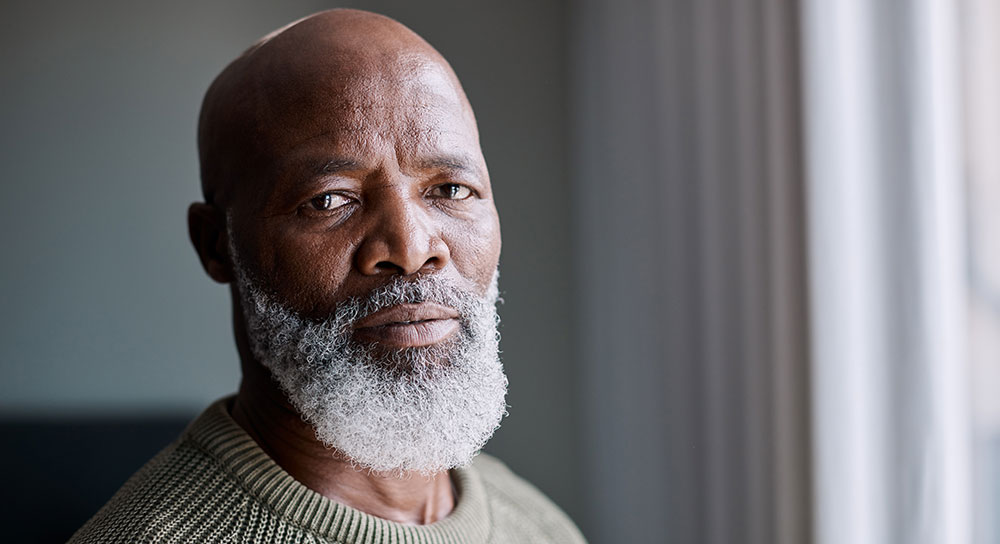 A mature man looks at the camera