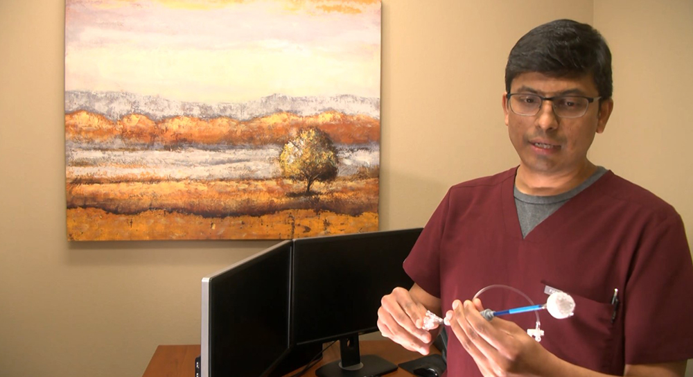 Male doctor shows medical device