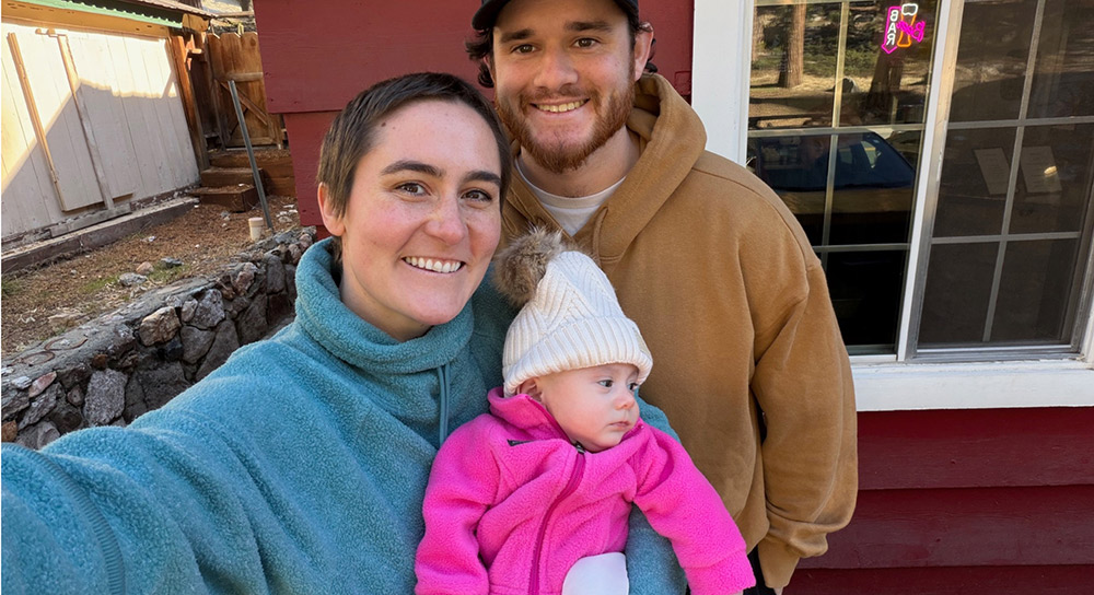 Mother, father and baby pose for a selfie