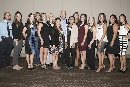 Butch Peters, President of the Leon S. Peters Foundation (standing center in the back row) is being honored by the nurse recipients of the Alice A. Peters Nursing Scholarship.