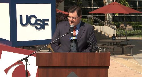 Craig Wagoner stands in front of a dais. 