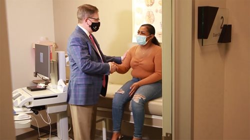 Dr. Derek Taggard shakes hands with patient Chyna Woods