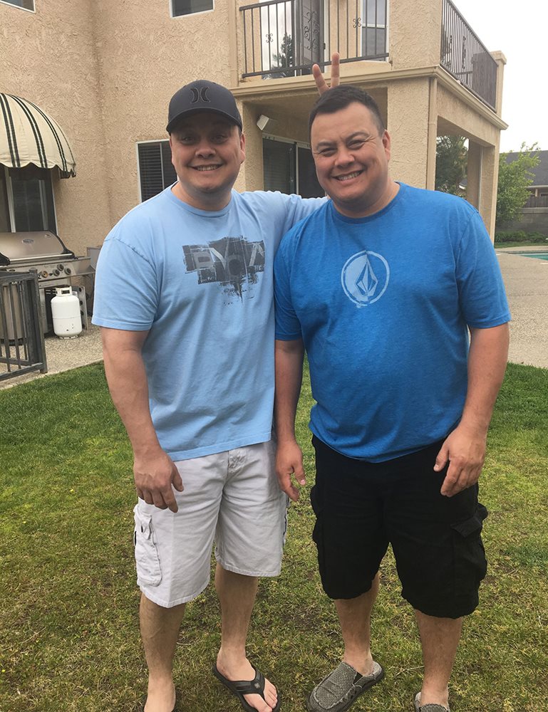 Shane and Sean Harrell pose playfully in their backyard