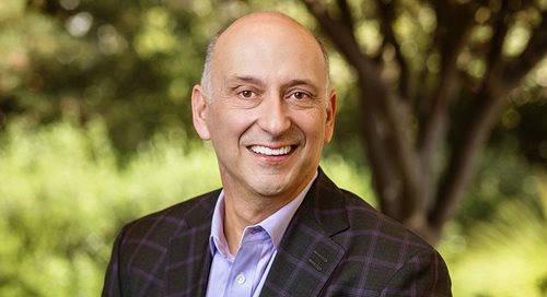 A portrait of Community Health System's president and CEO Craig Castro, who sits outside in front of a backdrop of trees