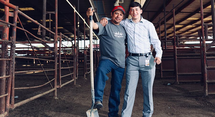 Abraham Alatorre and his father stand in a dairy