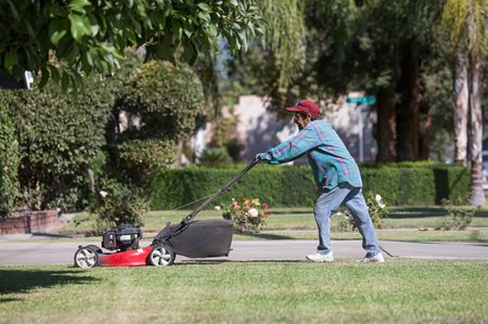 Barbara Hernandez mows her lawn