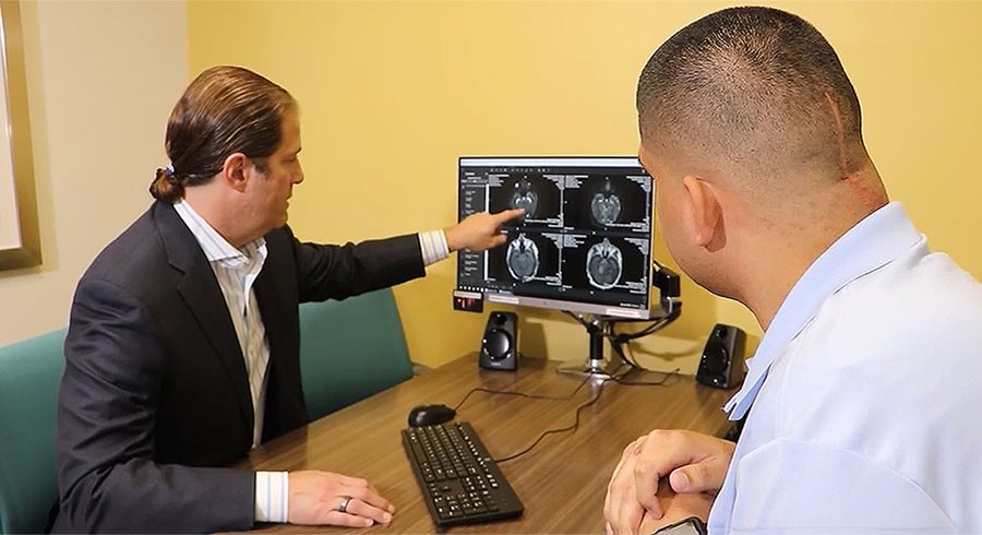 Dr. Levine and Andrew Caquias look at brain scans