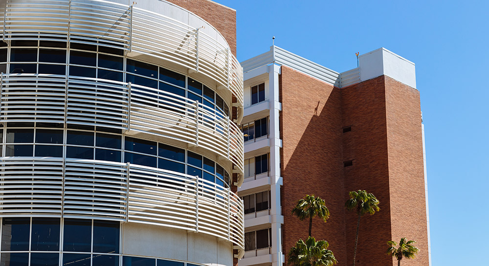 An exterior shot of Community Regional Medical Center with a bright blue sky behind it.