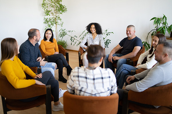 A group of diverse people sitting in a small circle
