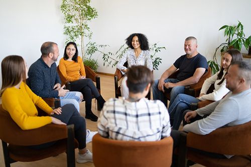 A group of diverse people sitting in a small circle