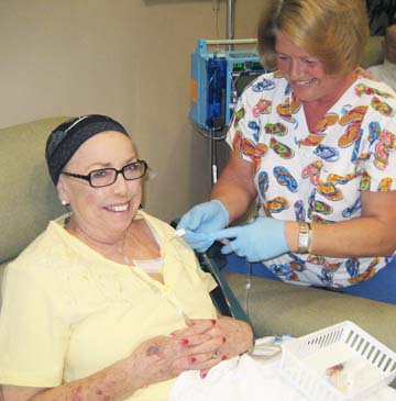 Anetta Jane Edwards smiles as a nurse attends to her